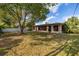 Expansive backyard featuring a large, screened lanai and lush landscaping at 1061 Radford Dr, Deltona, FL 32738