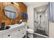 Beautiful bathroom featuring bamboo accent wall, an updated vanity, and a modern walk-in shower at 1061 Radford Dr, Deltona, FL 32738