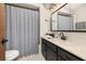 Clean bathroom with a stylish vanity, modern fixtures, and a shower with a striped curtain at 1061 Radford Dr, Deltona, FL 32738