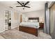 Comfortable bedroom with a decorative ceiling fan, and a carved wood bed with patio door access at 1061 Radford Dr, Deltona, FL 32738