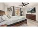 Well-lit bedroom featuring a ceiling fan, comfortable carved wood bed, dresser and a flatscreen television at 1061 Radford Dr, Deltona, FL 32738