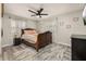 Cozy bedroom showcasing a decorative ceiling fan, floral curtains and a luxurious carved wood bed at 1061 Radford Dr, Deltona, FL 32738