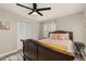 Comfortable bedroom featuring a decorative ceiling fan, a carved wood bed, and ample closet space at 1061 Radford Dr, Deltona, FL 32738