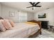 Comfortable bedroom with ceiling fan and media featuring a carved wood bed and a flatscreen television at 1061 Radford Dr, Deltona, FL 32738