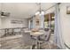 Cozy dining area with a round table, four chairs, and natural light from the sliding glass door at 1061 Radford Dr, Deltona, FL 32738