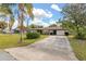 Charming single story home featuring a well-maintained lawn, mature landscaping, and a concrete driveway at 1061 Radford Dr, Deltona, FL 32738