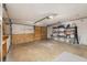 Spacious garage with shelving, workbench, and wooden paneled doors, perfect for storage and projects at 1061 Radford Dr, Deltona, FL 32738