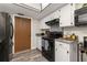 A closer view of the kitchen with stainless steel appliances, a built in microwave, and a tile backsplash at 1061 Radford Dr, Deltona, FL 32738