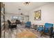 Open-concept living room with a large window, ceiling fan, and two stylish blue accent chairs at 1061 Radford Dr, Deltona, FL 32738