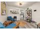 Bright living room with modern light fixture, wood floors, and an open view into the kitchen at 1061 Radford Dr, Deltona, FL 32738