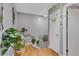 Bright hallway filled with plants leading to other rooms and hardwood flooring throughout at 1120 Portland Ave # 2, Orlando, FL 32803