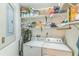 Functional laundry room with washer, dryer, storage shelves, and cleaning supplies at 1120 Portland Ave # 2, Orlando, FL 32803