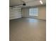 Clean garage featuring a speckled epoxy floor, window, and an automatic door opener for convenience at 1328 Burnley Ct, Kissimmee, FL 34758