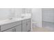 Modern bathroom features double vanity, quartz countertop, gray cabinets, and a large mirror at 144 Jones Fish Camp Rd, Edgewater, FL 32141
