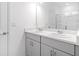 Bright bathroom with double vanity sinks, a large mirror, and white countertops with modern fixtures at 144 Jones Fish Camp Rd, Edgewater, FL 32141