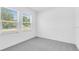 Inviting bedroom with plush carpeting and two windows, perfect for relaxation and natural light at 144 Jones Fish Camp Rd, Edgewater, FL 32141