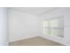 Sunlit bedroom with neutral walls, carpeted floor, a closet and a bright window at 144 Jones Fish Camp Rd, Edgewater, FL 32141