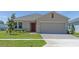 Charming single-story home features manicured lawn, brick driveway and neutral tones at 144 Jones Fish Camp Rd, Edgewater, FL 32141