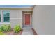 Close-up of the front door and entryway with manicured landscaping at 144 Jones Fish Camp Rd, Edgewater, FL 32141