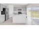 Bright kitchen features stainless steel appliances, center island and sliding glass doors at 144 Jones Fish Camp Rd, Edgewater, FL 32141