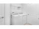 Well-lit laundry room with modern appliances, white trim and storage at 144 Jones Fish Camp Rd, Edgewater, FL 32141