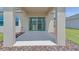 Covered patio with ample space for entertaining, supported by textured columns at 144 Jones Fish Camp Rd, Edgewater, FL 32141