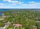 Extensive aerial view of homes nestled among trees near a beautiful waterfront area at 1511 Grandview Blvd, Kissimmee, FL 34744