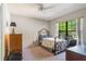 Bedroom featuring a wrought iron bed frame, large window with a view, and light colored walls and carpet at 1511 Grandview Blvd, Kissimmee, FL 34744