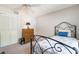 This bedroom features a black wrought iron bed frame, a closet, and a large window with natural light at 1511 Grandview Blvd, Kissimmee, FL 34744