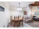 Cozy dining room with wood table, chairs, and chandelier, near a comfortably furnished living space at 1511 Grandview Blvd, Kissimmee, FL 34744