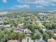 Aerial view of a home nestled in a mature, tree-filled neighborhood with a lake at 1630 Lasbury Ave, Winter Park, FL 32789