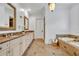 Bathroom with double sink vanity, decorative mirrors and marble countertops at 1630 Lasbury Ave, Winter Park, FL 32789