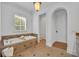 Bright bathroom featuring a soaking tub, stone flooring, and neutral tiling at 1630 Lasbury Ave, Winter Park, FL 32789