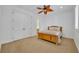 Simple bedroom featuring a wood frame bed, ceiling fan, and plantation shutters at 1630 Lasbury Ave, Winter Park, FL 32789