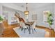 Elegant dining space with hardwood floors, natural light, and stylish decor; staircase leading to the second floor at 1630 Lasbury Ave, Winter Park, FL 32789