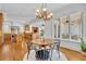 Bright dining area with wood floors and a chandelier, next to the open kitchen at 1630 Lasbury Ave, Winter Park, FL 32789