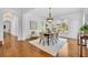 Formal dining room with hardwood floors, chandelier, and ample natural light from large windows at 1630 Lasbury Ave, Winter Park, FL 32789