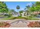 Long brick paver driveway and lush landscaping leading to beautiful homes; palm tree shadows dappling the walkway at 1630 Lasbury Ave, Winter Park, FL 32789