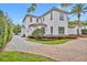 Beautiful home exterior with brick driveway, lush landscaping, and a manicured lawn at 1630 Lasbury Ave, Winter Park, FL 32789