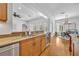 Open-concept kitchen with granite countertops and stainless steel appliances, adjacent to the dining area at 1630 Lasbury Ave, Winter Park, FL 32789