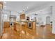 Spacious kitchen featuring custom wood cabinetry, granite countertops, and stainless steel appliances with hardwood flooring at 1630 Lasbury Ave, Winter Park, FL 32789