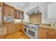 A gourmet kitchen featuring a stainless steel range, granite countertops, and custom wood cabinetry at 1630 Lasbury Ave, Winter Park, FL 32789