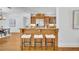 Kitchen featuring a breakfast bar with seating, stainless steel appliances, and custom wood cabinets at 1630 Lasbury Ave, Winter Park, FL 32789