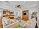 Bright living room with hardwood floors, a ceiling fan, and views of the open-concept kitchen at 1630 Lasbury Ave, Winter Park, FL 32789