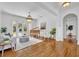 Bright living room with hardwood floors, a piano, French doors to a pool, and neutral-toned furniture at 1630 Lasbury Ave, Winter Park, FL 32789