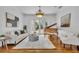 Cozy living room featuring a piano, neutral-toned furniture, hardwood floors, and French doors at 1630 Lasbury Ave, Winter Park, FL 32789