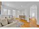 Cozy living room with hardwood floors, neutral decor, and ample natural light at 1630 Lasbury Ave, Winter Park, FL 32789