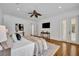 Bright main bedroom with hardwood floors, ceiling fan, and french doors to the exterior at 1630 Lasbury Ave, Winter Park, FL 32789