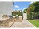 Outdoor kitchen features stainless steel grill, granite counters and stone base; a serene outdoor cooking experience at 1630 Lasbury Ave, Winter Park, FL 32789