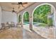 Covered patio with comfortable seating, ceiling fans, and views of the backyard swimming pool at 1630 Lasbury Ave, Winter Park, FL 32789